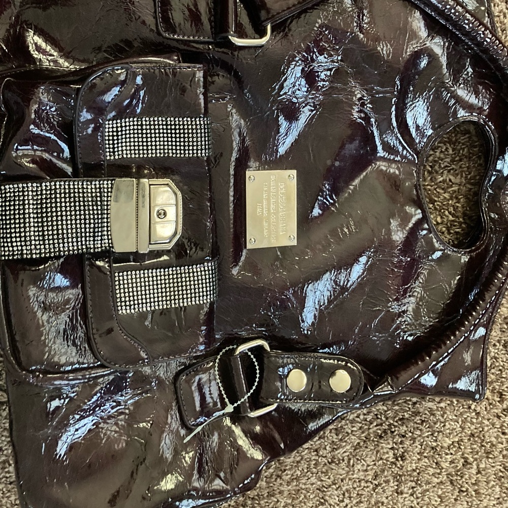 Selling a purse, color is dark purple it’s leather